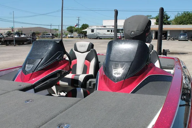 Slide: The Image of 2019 Skeeter FX21 LE boat with dual consoles and seating, parked outdoors. - 8