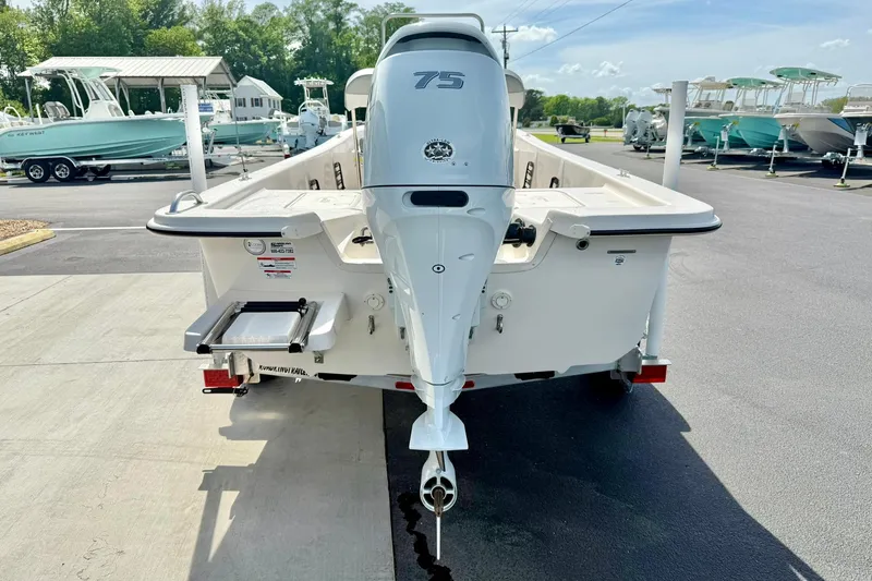 Slide: The Image of 2025 Carolina Skiff E18 JVX CC boat with 75 HP engine, parked on a trailer. - 31