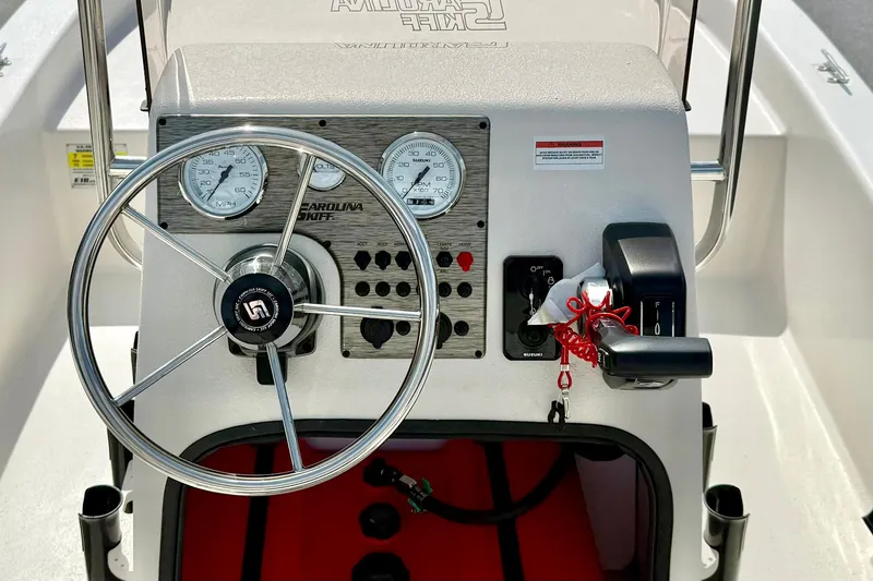 Slide: The Image of 2025 Carolina Skiff E18 JVX CC boat console with steering wheel and gauges. - 32