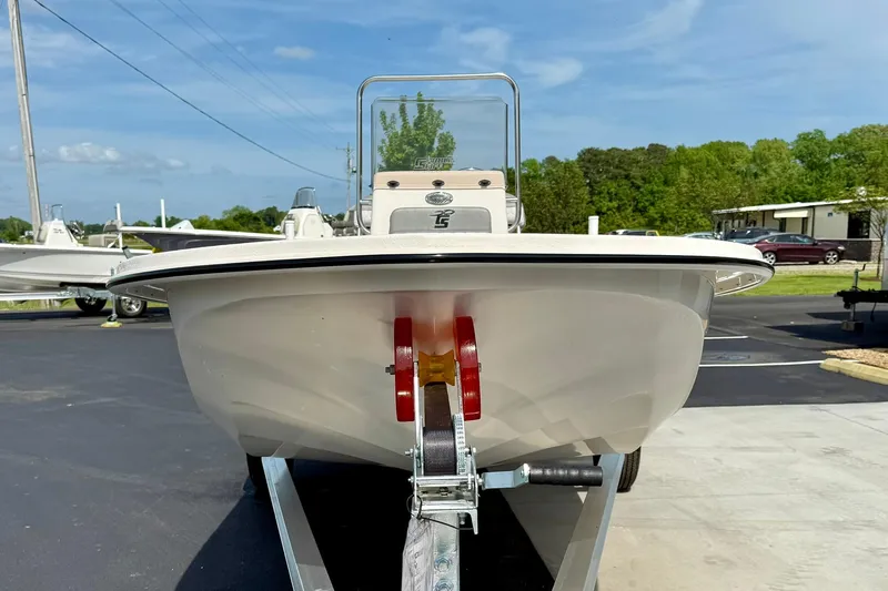 Slide: The Image of 2025 Carolina Skiff E18 JVX CC boat on trailer, parked outdoors on a sunny day. - 36