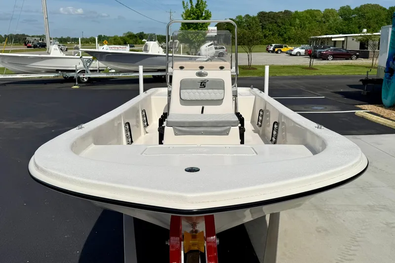 Slide: The Image of 2025 Carolina Skiff E18 JVX CC boat on display in a parking lot. - 37
