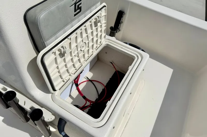 Slide: The Image of 2025 Carolina Skiff E18 JVX CC boat storage compartment with open lid and visible wiring. - 41