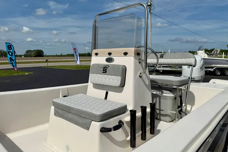 Slide: The Image of 2025 Carolina Skiff E18 JVX CC boat with center console and seating, displayed outdoors. - 42