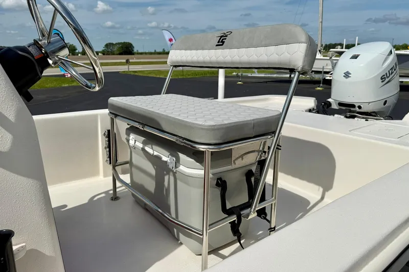 Slide: The Image of 2025 Carolina Skiff E18 JVX CC boat interior with cushioned seat and steering wheel. - 46