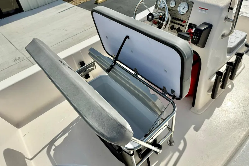 Slide: The Image of 2025 Carolina Skiff E18 JVX CC boat interior with open storage compartment and steering console. - 48