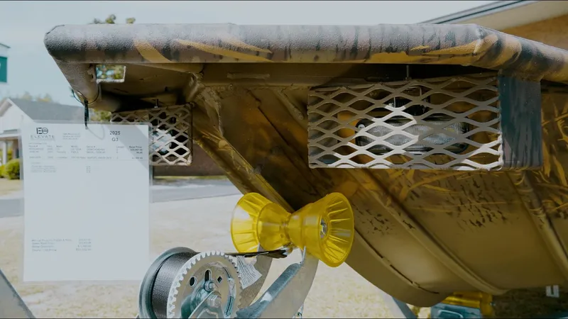 Slide: The Image of 2025 G3 Gator Tough 16 DK boat trailer with winch and camouflage design. - 10