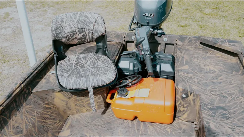 Slide: The Image of 2025 G3 Gator Tough 16 DK boat interior with camo seat and orange fuel tank. - 11