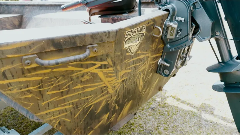 Slide: The Image of 2025 G3 Gator Tough 16 DK boat with camouflage design and motor detail. - 18