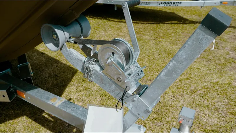 Slide: The Image of Trailer winch system for 2025 G3 Gator Tough 16 DK boat on grass. - 20