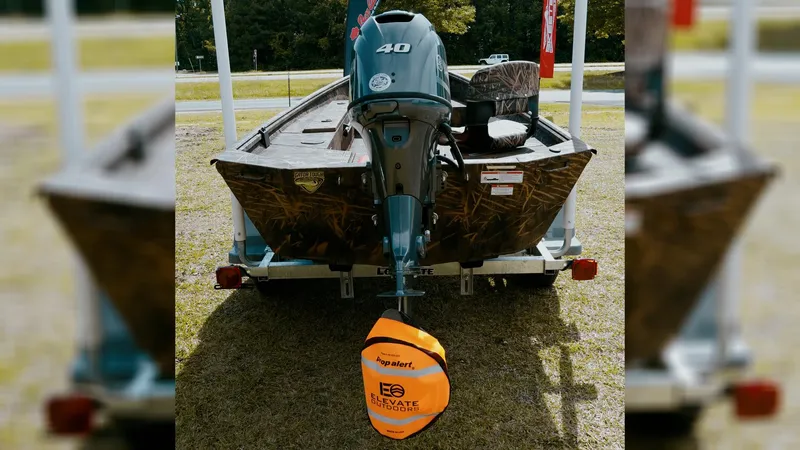 Slide: The Image of 2025 G3 Gator Tough 16 DK boat with 40 HP motor on trailer, outdoors. - 22