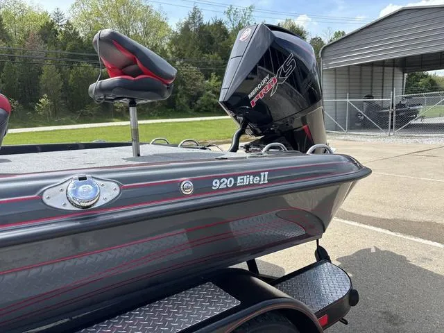 Slide: The Image of 2023 Phoenix 920 Elite II boat with Mercury engine, parked outdoors. - 13