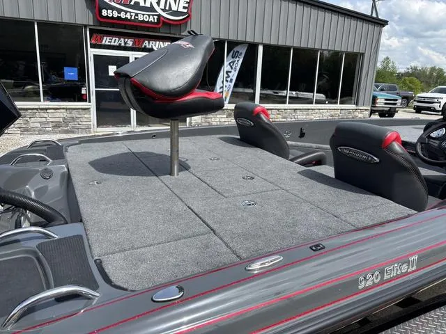 Slide: The Image of 2023 Phoenix 920 Elite II boat with seating, displayed at a marine dealership. - 4