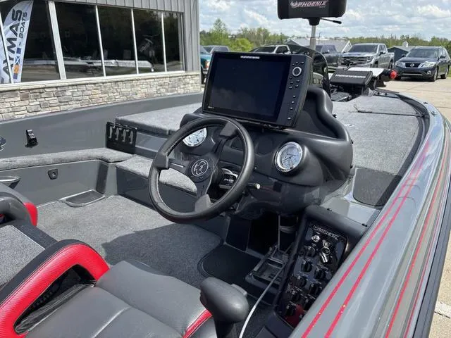 Slide: The Image of 2023 Phoenix 920 Elite II boat dashboard with steering wheel and navigation display. - 5