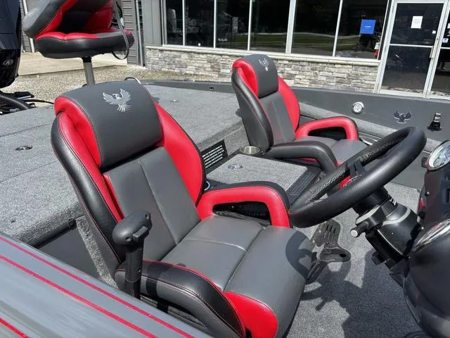 Slide: The Image of 2023 Phoenix 920 Elite II boat interior with red and gray seats, steering wheel, and dashboard. - 6