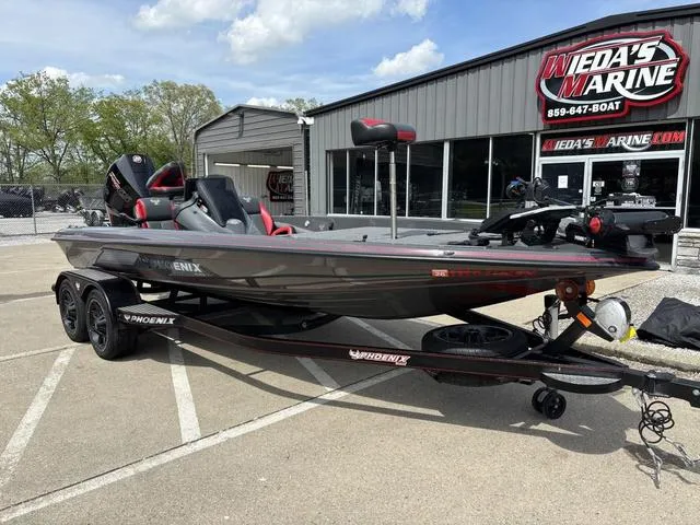 Slide: The Image of 2023 Phoenix 920 Elite II boat at Weda's Marine dealership, parked outdoors. - 8