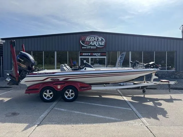 Slide: The Image of 2011 Skeeter FX21 boat on trailer outside dealership, featuring sleek design and powerful engine. - 1