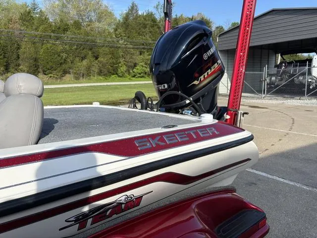 Slide: The Image of 2011 Skeeter FX21 boat with Yamaha VMAX engine, parked outdoors. - 11
