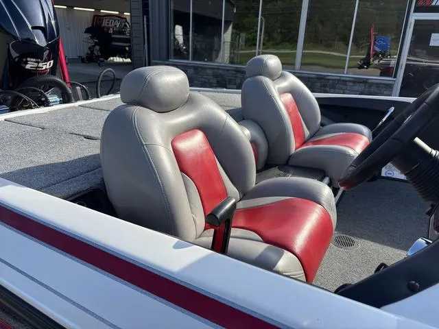 Slide: The Image of 2011 Skeeter FX21 boat interior with gray and red seats, steering wheel visible. - 4