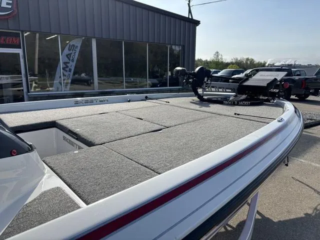 Slide: The Image of 2011 Skeeter FX21 boat with spacious deck, parked outside a showroom. - 6