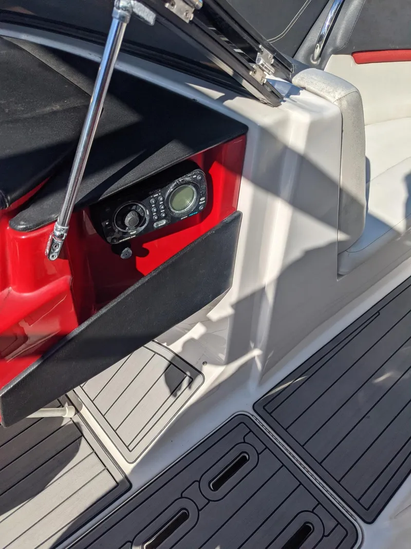 Slide: The Image of 2014 Four Winns H230SS boat interior with control panel and seating area. - 5