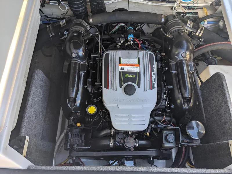 Slide: The Image of Engine compartment of a 2014 Four Winns H230SS boat, featuring a 350 MAG engine. - 8