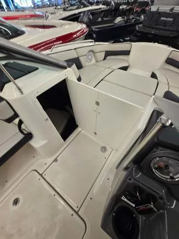 Slide: The Image of 2015 Yamaha AR210 boat interior with open storage compartment and seating area. - 12