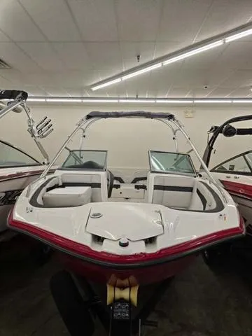 Slide: The Image of 2015 Yamaha AR210 boat with red and white design in showroom. - 2