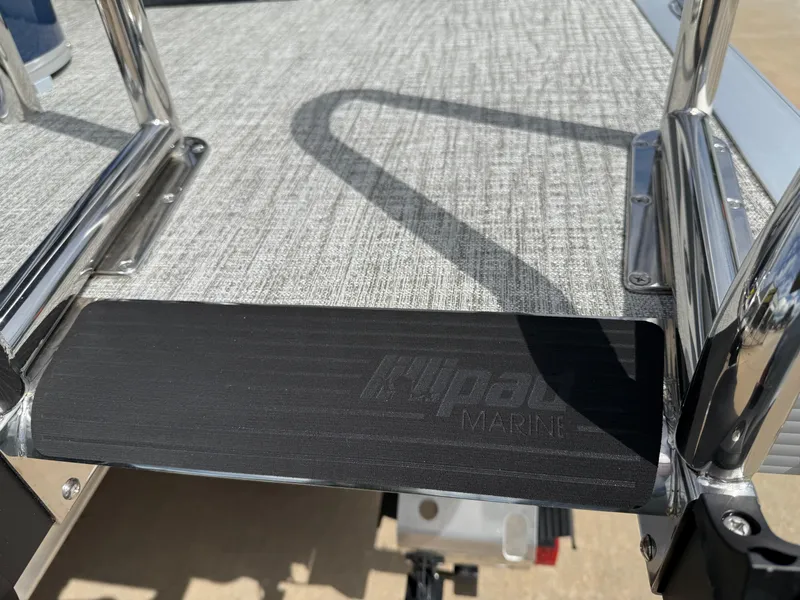 Slide: The Image of Close-up of Avalon LSZ Quad Lounger Shift 2025 boat deck with metal railings. - 11