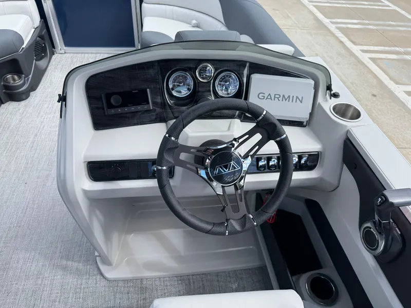 Slide: The Image of 2025 Avalon LSZ Quad Lounger Shift dashboard with Garmin navigation and modern steering wheel. - 22