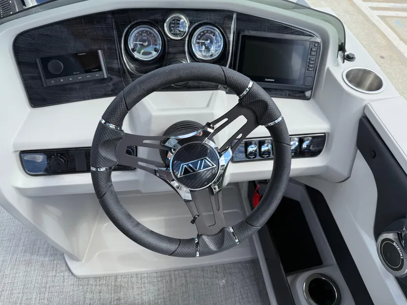 Slide: The Image of Steering wheel and dashboard of 2025 Avalon LSZ Quad Lounger Shift boat. - 25