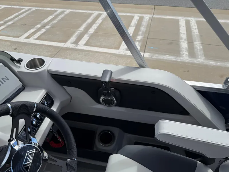 Slide: The Image of 2025 Avalon LSZ Quad Lounger Shift boat interior with steering wheel and control panel. - 28