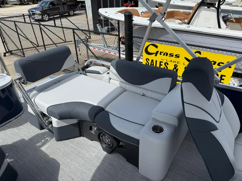Slide: The Image of 2025 Avalon LSZ Quad Lounger Shift boat interior with gray and black seating, cup holder, and speaker. - 41