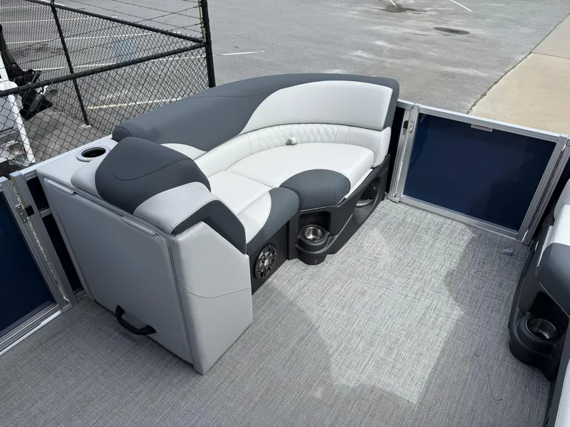 Slide: The Image of 2025 Avalon LSZ Quad Lounger Shift boat interior with gray seating and cup holders. - 47