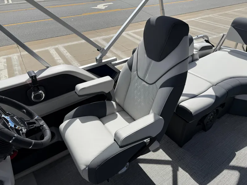 Slide: The Image of 2025 Avalon LSZ Quad Lounger Shift boat interior with modern seating and steering wheel. - 49