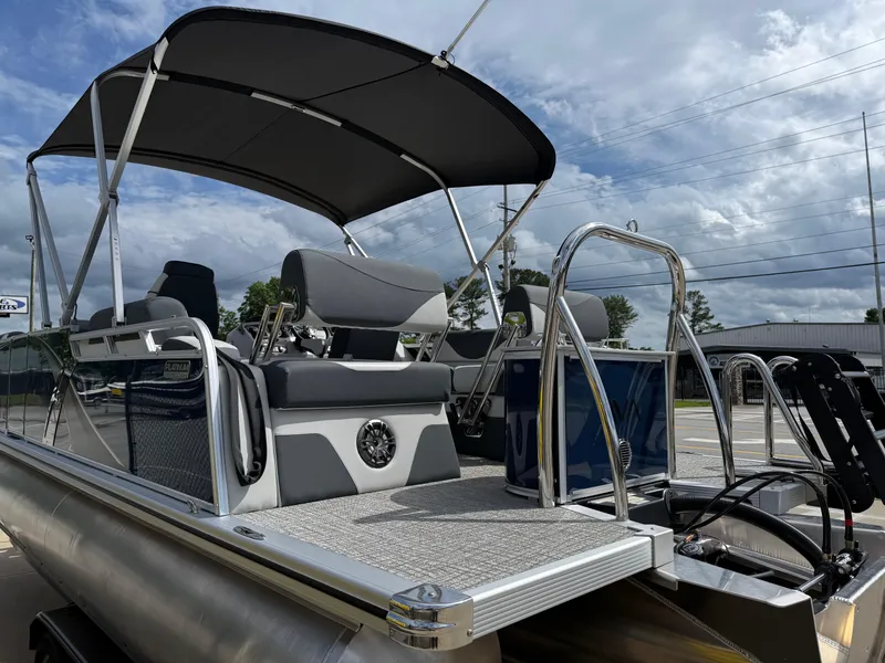 Slide: The Image of 2025 Avalon LSZ Quad Lounger Shift pontoon boat with canopy, parked outdoors. - 8