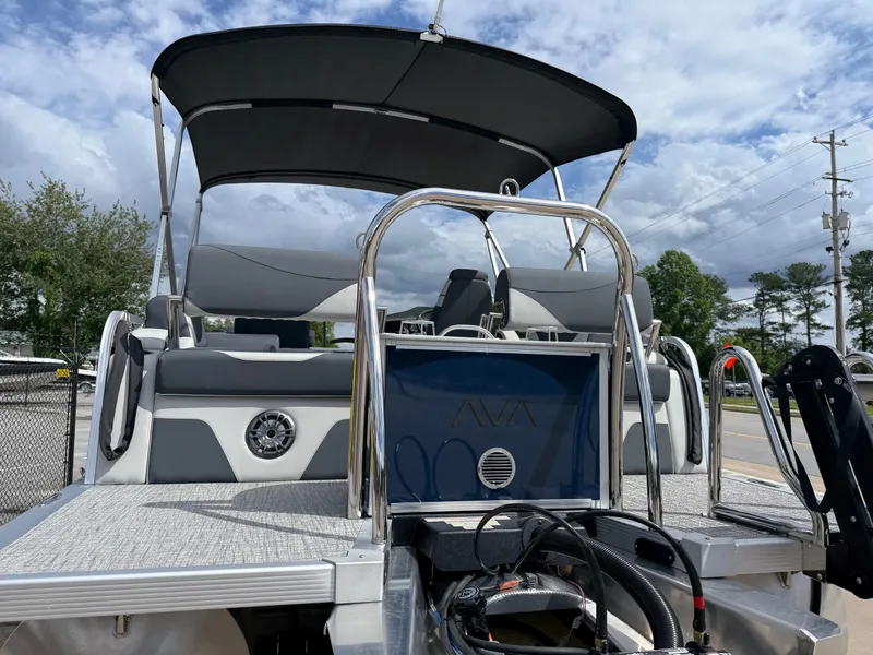 Slide: The Image of 2025 Avalon LSZ Quad Lounger Shift pontoon boat with canopy and seating, docked outdoors. - 9