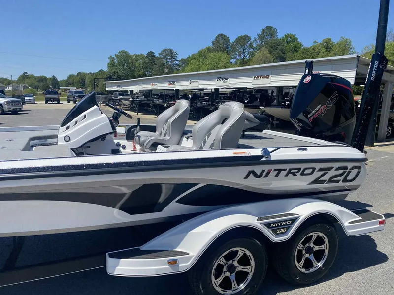 Slide: The Image of 2024 Nitro Z20 Pro boat with dual seats and trailer in a dealership lot. - 8