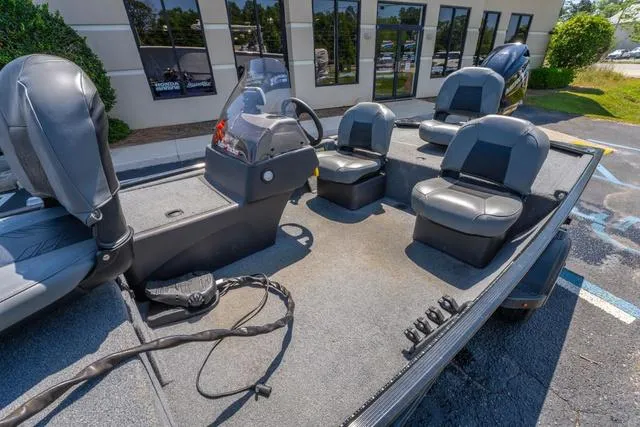 Slide: The Image of 2021 Tracker BASS TRACKER® Classic XL boat with seating and console, parked outdoors. - 12
