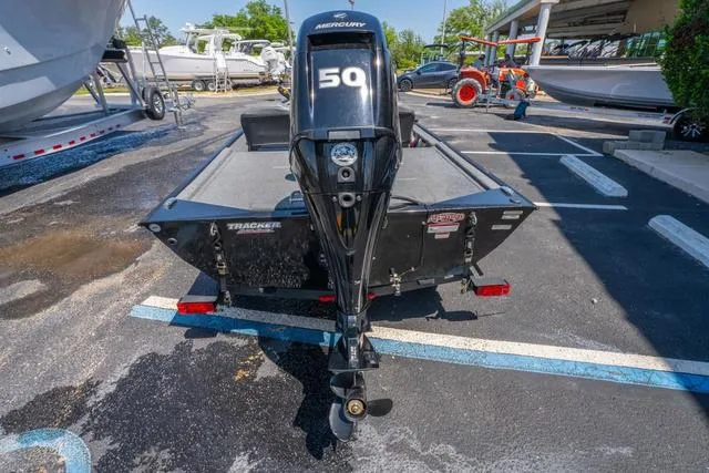 Slide: The Image of 2021 Tracker BASS TRACKER® Classic XL boat with Mercury 50 engine in a parking lot. - 4