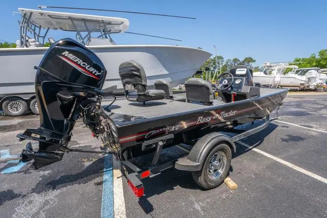 Slide: The Image of 2021 Tracker BASS TRACKER® Classic XL boat with Mercury engine in a parking lot. - 5