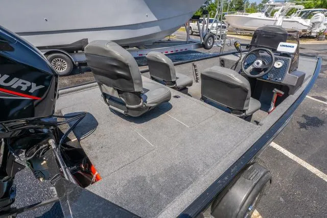 Slide: The Image of 2021 Tracker BASS TRACKER® Classic XL boat with seating and steering console, parked outdoors. - 9