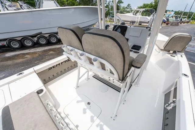 Slide: The Image of 2023 Sea Pro 228 Bay boat interior with seating and rod holders. - 11