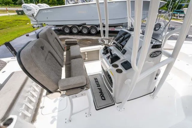 Slide: The Image of 2023 Sea Pro 228 Bay boat interior with dual seats and control console. - 12
