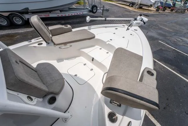 Slide: The Image of 2023 Sea Pro 228 Bay boat with cushioned seating and storage compartments. - 17