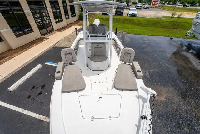 Slide: The Image of 2023 Sea Pro 228 Bay boat with spacious deck and seating, parked outdoors. - 18