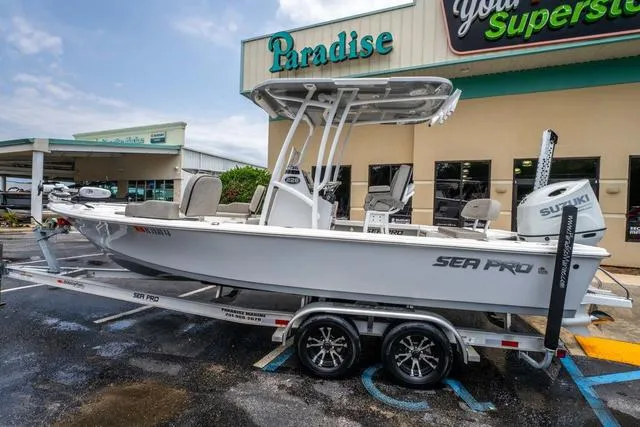 Slide: The Image of 2023 Sea Pro 228 Bay boat on trailer outside Paradise store. - 2
