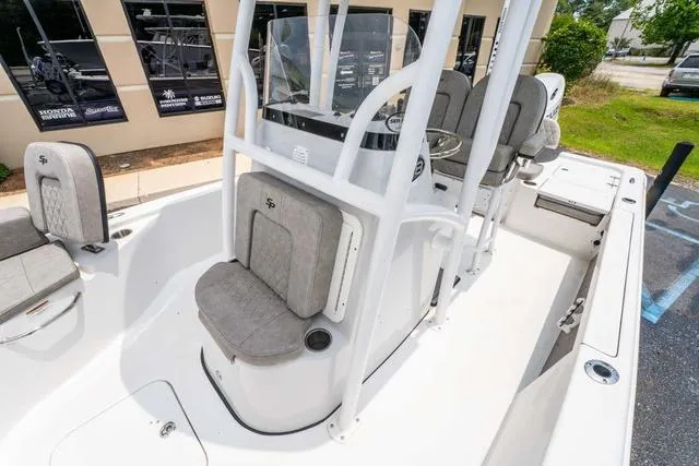 Slide: The Image of 2023 Sea Pro 228 Bay boat interior with seating and console, showcasing modern design. - 21
