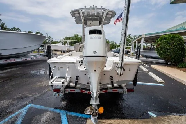 Slide: The Image of 2023 Sea Pro 228 Bay boat, rear view, parked on a trailer in a lot. - 4