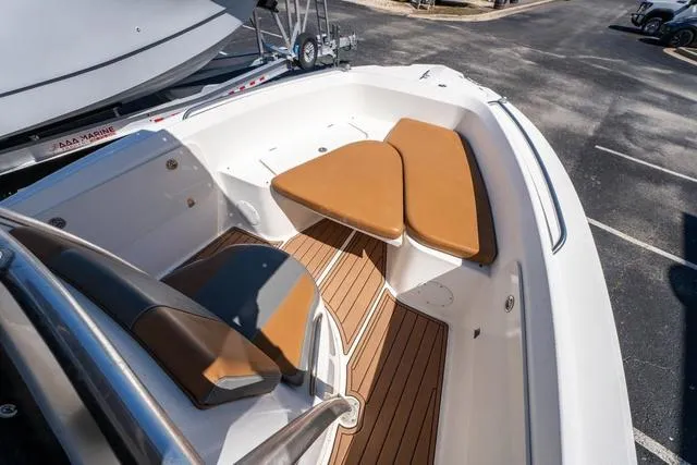 Slide: The Image of 2004 Cobia 234 boat interior with tan seating and wood flooring. - 15