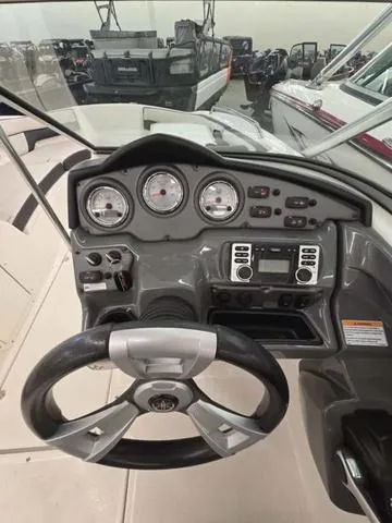Slide: The Image of 2015 Yamaha AR210 boat dashboard with steering wheel and control panel. - 13